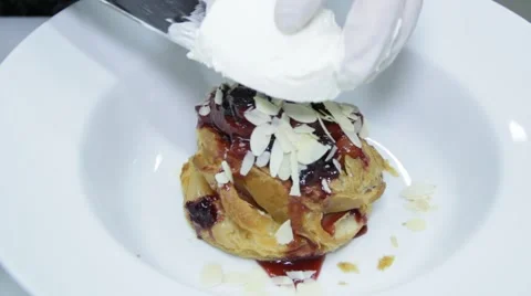 Cook is adding ice-cream on the desert - bun with cherry 스톡 동영상 48395910