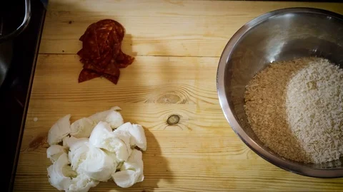 Cook adding two teaspoons of butter to the grated cheese and stirring it. 4K Stock Footage 83117213
