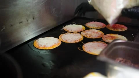 Cook Adds Cheese to Quesabirria Tacos on Griddle Stock Footage 342786480