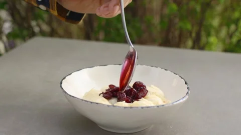 The cook adds cherry jam to lazy dumplings. Stock Footage 277135718