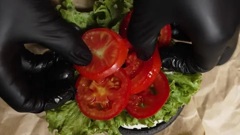 Cook adds chopped tomatoes Stock Footage 297004117