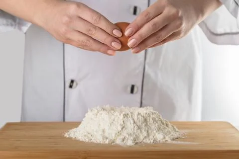 Cook adds an egg Stock Photos