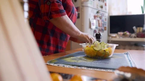 The cook adds spices and salt to the salad. Side view. Cool vegetable salad. Stock Footage 123724889