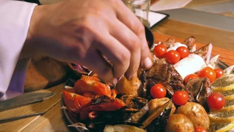 Cook adds spices to the dish. Stock Footage 122398950