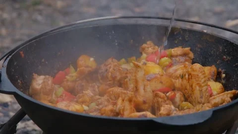 The cook adds water to the cauldron. Adding water to the dish. Water is poured Stock Footage 278868674