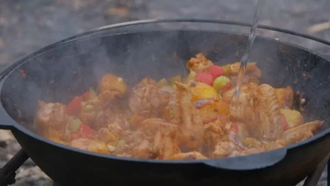 The cook adds water to the cauldron. Adding water to the dish. Water is poured Stock Footage 279271789