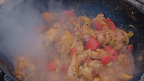 The cook adds water to the cauldron. Adding water to the dish. Water is poured i Stock Footage 282829913