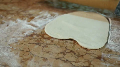 Cook aligns the dough sheet with a rolling pin, shaping the dough. Video stock 119696895