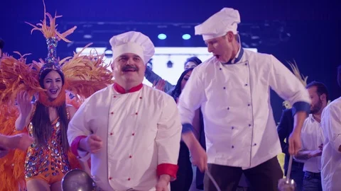 Cook and waiter dancers having fun dancing at a colorful party . Stock Footage 123730816