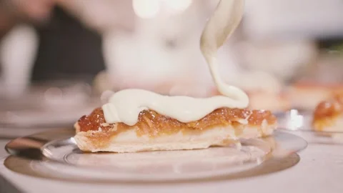 Cook applies a layer of cream to a slice of cake. dessert preparation in the Stock Footage 260335205