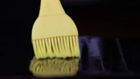 The cook applies oil to baking sheet, rubber kitchen brush, pizza making, dough Stock Footage 222074733