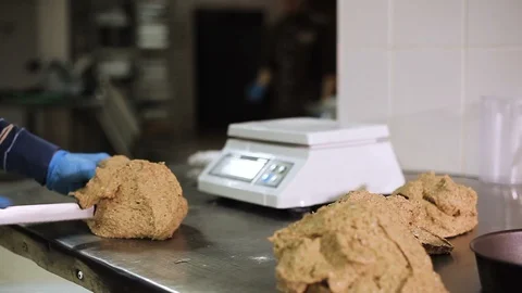 Cook at the bakery smears bakeware with flour. Close-up Video stock 106459015