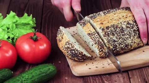 Cook Bakes Bread on the Board. Bread With Sesame Seeds. on the Table Lay the 動画素材 61882818