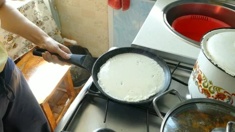 Cook bakes pancakes in a pan Stock Footage 136735562