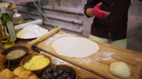 The cook bakes a pie stuffed with grapes. There are ingredients on the table. Stock Footage 159369769