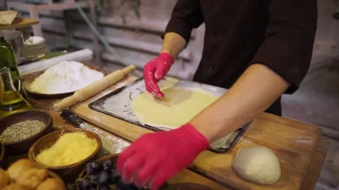 The cook bakes a pie stuffed with grapes. Stock Footage 159369846