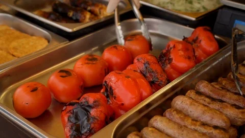 The cook is baking the baked tomatoes on a plate. Stock Footage 84581735