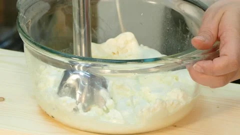 The cook is beating the cheese with a blender. Stock-Footage 88502237