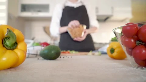 The cook in black apron throws pasta on the table towards the camera Stock Footage 131454892