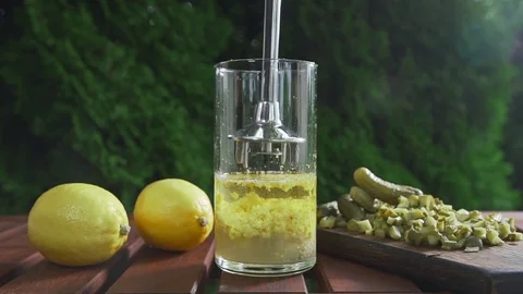 The cook blends sauce ingredients in a long glass, cooking outdoors, cooking Stock Footage 77548720