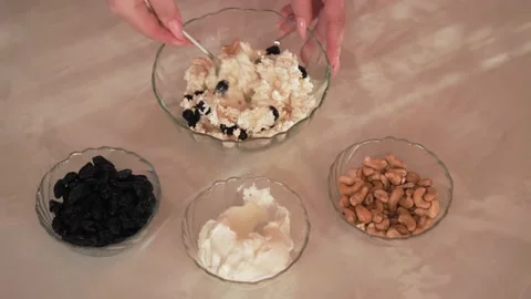 The cook boils the cottage cheese, beats, adds raisins and nuts Stock Footage 171251453