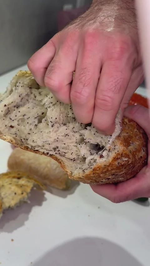 Cook break appetizing loaf of bread. Baker hands breaking homemade bread Stock Footage 323379042