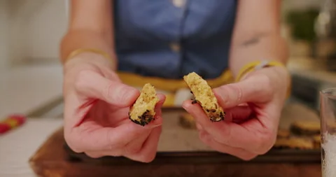 Cook breaking a biscuit in half close up hands Stock Footage 247785136