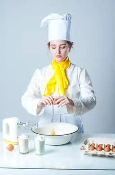 Cook breaking egg Stock Photos