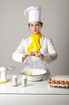 Cook breaking egg Stock Photos