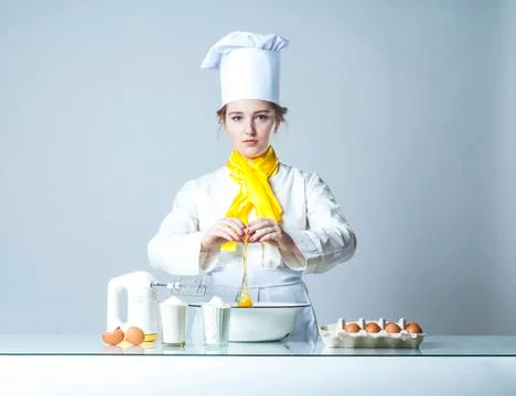 Cook breaking egg Stock Photos