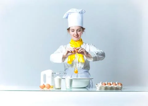 Cook breaking egg Stock Photos