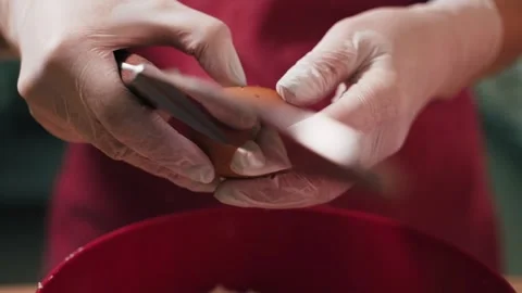 Cook breaks the chicken egg with knife Stock Footage 155203098