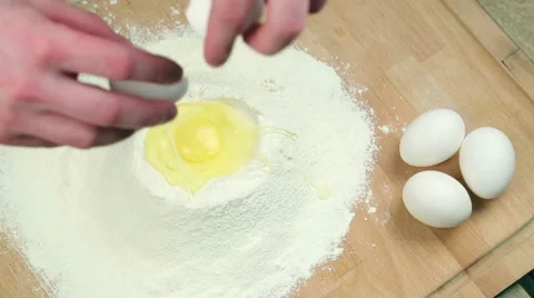 The cook breaks an egg into the flour Stock Footage 62408085