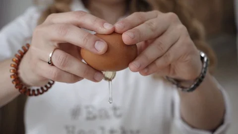Cook breaks the egg in two halves Stock Footage 116714121