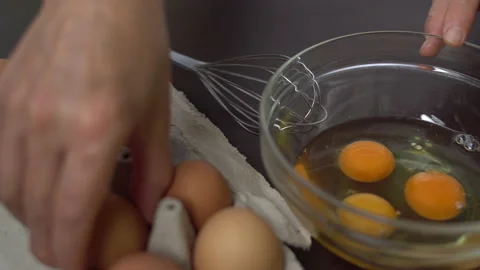 Cook  breaks eggs, adds salt and whisks the eggs Stock Footage 136491232