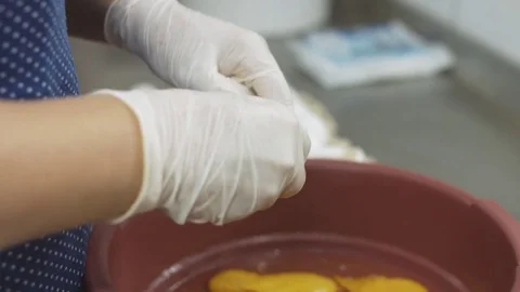 Cook breaks raw eggs into the bowl Stock Footage 77740499