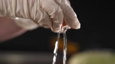 The cook breaks the shell of a chicken egg. Pours protein and egg yolk. Video stock 232878186