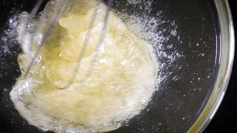 The cook brews the eggs. Whisk egg white. Black background. Slow motions Stock Footage 86551411