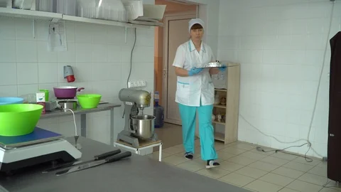 The cook brings a batch of pastries to the kitchen Stock Footage 85661826