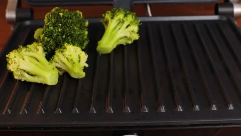 Cook broccoli on an electric grill. Stock Footage 237916095