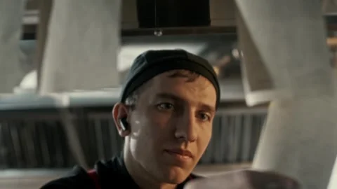 Cook in cafe kitchen taking an order from customer with a receipt on sticker Stock Footage 315231515