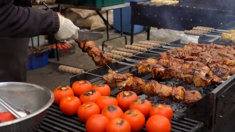 The cook checks the readiness of the meat on the grill. Barbecue meat grillin Stock Footage 84580473