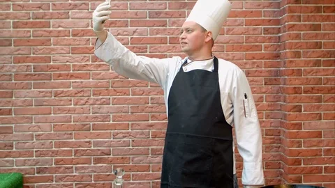 Cook chef making selfie via smartphone in the kitchen Vídeos de archivo 74939354