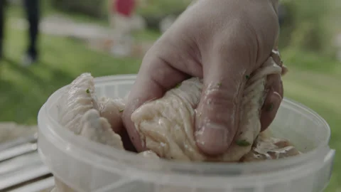 Cook Chef Take Marinated Chicken Meat from Bowl Stock Footage 144797976