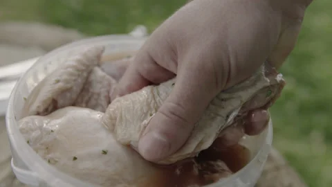 Cook Chef Taking Marinated Chicken Legs from Bowl Video stock 144797915