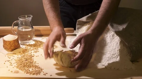Cook chews bread on a wooden table Stock Footage 76507903
