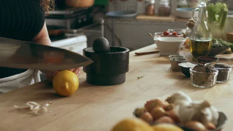 Cook chopping and squeezing lemon using mortar and pestle for an octopus carpacc Stock Footage 199459808