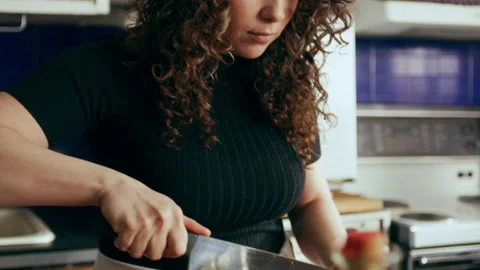 Cook chopping celery on cutting board surrounded by a variety of ingredients in Stock Footage 199462081