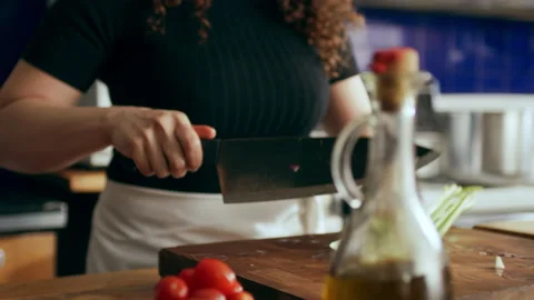 Cook chopping celery on cutting board in a large kitchen with an array of a equi Stock Footage 199462291