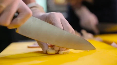 A cook chopping a garlic Stock Footage 67863116